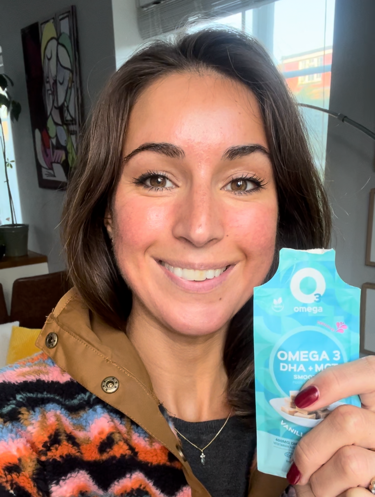 Sara Fenn CEO O3Omega Smoothies holding her fafvourite O3Smoothies Vanilla Fudge brain boosting and delicious liposomal supplement, perfect for adults, children, cognitive focus, memory, brain health, pregnancy, and mental energy. 